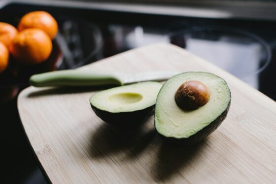 sliced avocado on brown wooden chopping board