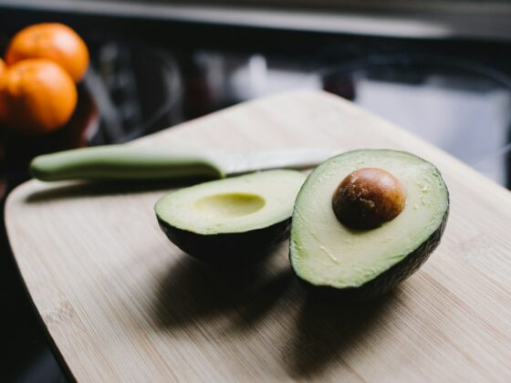 sliced avocado on brown wooden chopping board